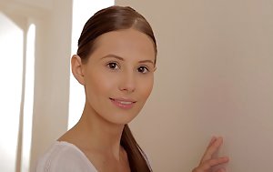 Ponytailed brunette dressed in all white shows her crotchless pantyhose